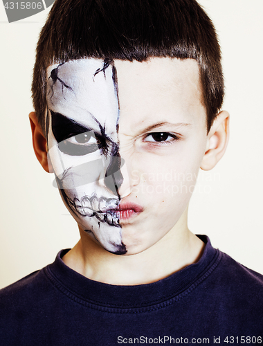 Image of little cute boy with facepaint like skeleton to celebrate hallow