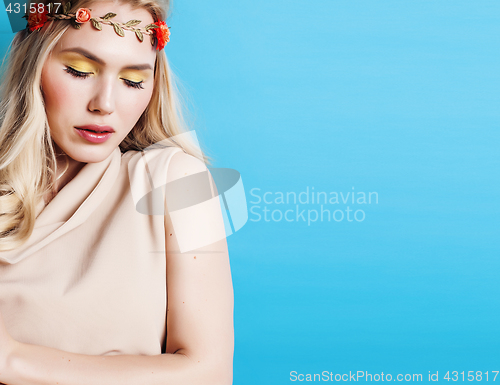 Image of young blond woman dressed like ancient greek godess, gold jewelry close up isolated, beautiful girl hands manicured red nails