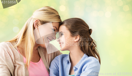 Image of happy girl with mother hugging over lights
