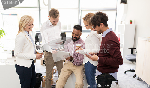 Image of business team with tablet pc and coffee at office