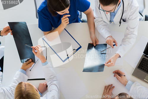 Image of doctors with spine x-rays and clipboards