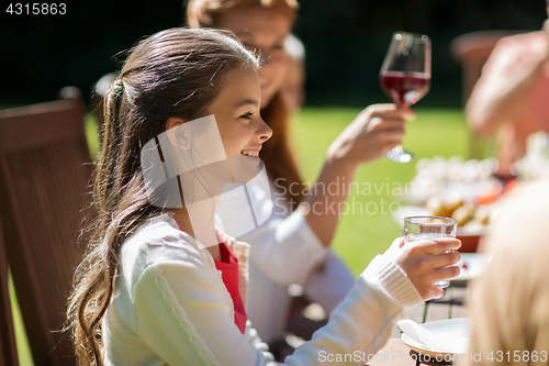 Image of happy girl with family at festive dinner