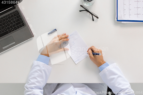 Image of doctor hands with prescription at clinic