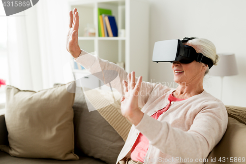 Image of old woman in virtual reality headset or 3d glasses