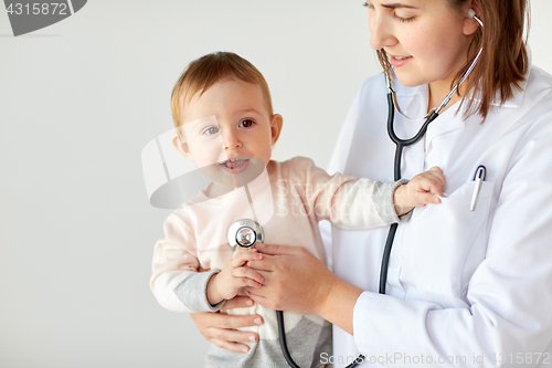 Image of doctor with stethoscope listening baby at clinic