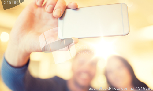 Image of close up of couple taking smartphone selfie