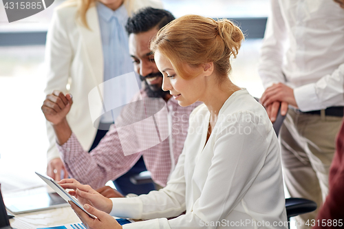Image of business team with tablet pc computer in office