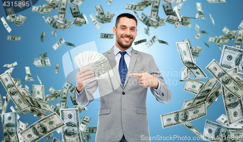 Image of smiling businessman with american dollar money