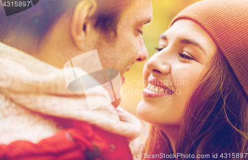 Image of close up of happy young couple kissing outdoors