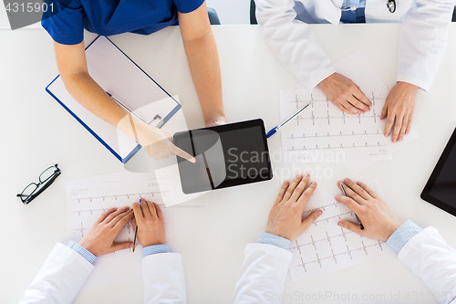 Image of doctors with cardiograms and tablet pc at hospital