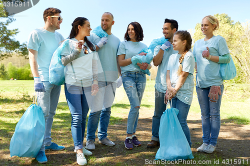 Image of group of volunteers with garbage bags in park