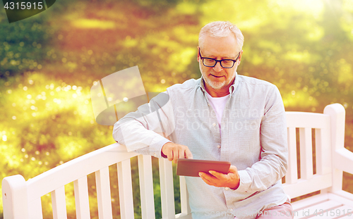 Image of senior man with tablet pc at summer park