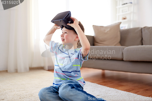 Image of little boy in vr headset or 3d glasses at home