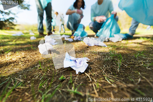 Image of volunteers with garbage bags cleaning park area