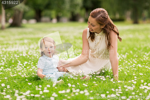 Image of happy mother with baby girl at summer park