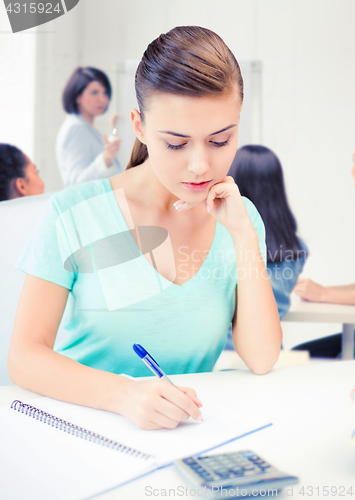 Image of student girl with notebook and calculator