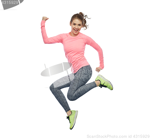 Image of happy smiling sporty young woman jumping in air