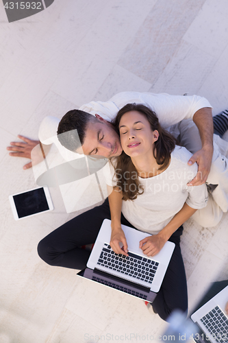 Image of couple using tablet and laptop computers top view