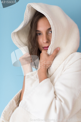 Image of woman in a white coat with hood isolated on blue background