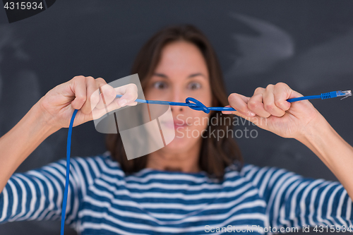 Image of woman holding a internet cable in front of chalk drawing board