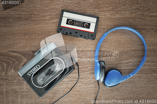 Image of Vintage walkman, cassete and headphones.