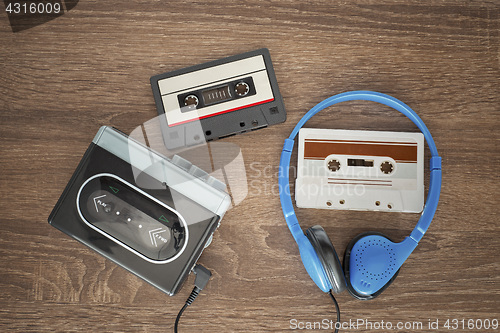 Image of Vintage walkman, cassete and headphones.