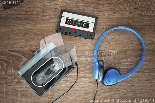 Image of Vintage walkman, cassete and headphones.