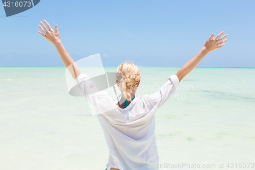 Image of Happy woman enjoying, relaxing joyfully in summer on tropical beach.