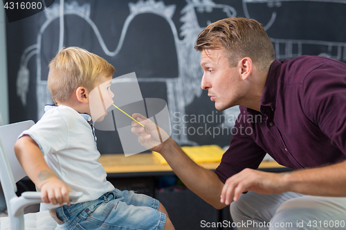 Image of Cute little boy at speechtherapist session.