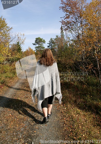 Image of Woman walking in autumn