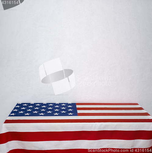 Image of American flag table near the white wall