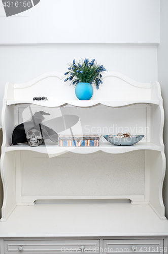 Image of Human skull in a white cabinet. Halloween theme