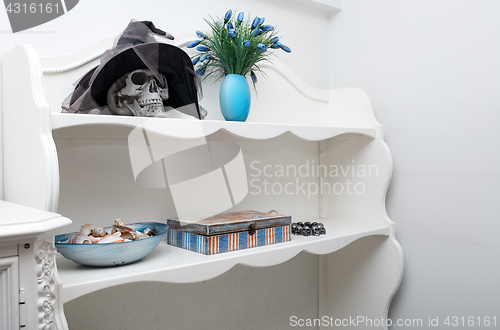 Image of Human skull in a white cabinet. Halloween theme