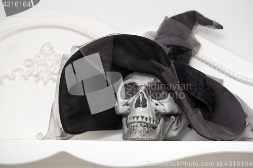 Image of Human skull in a white cabinet. Halloween theme