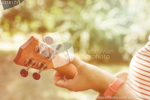 Image of Anonymous woman playing ukulele