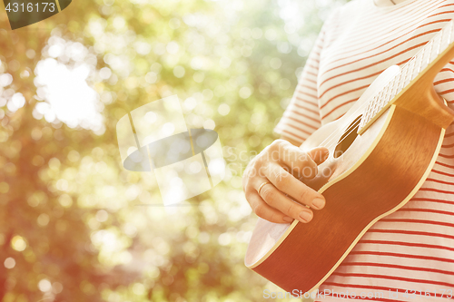 Image of Anonymous woman playing ukulele