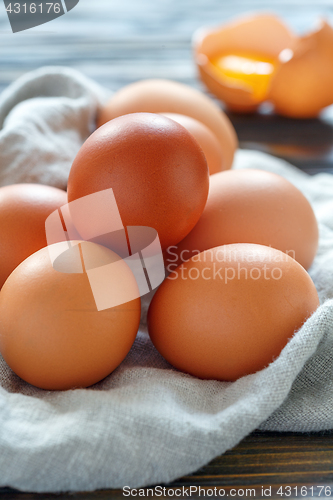 Image of Chicken eggs and broken eggshell with the yolk.
