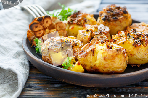 Image of Baked potatoes with spices, olive oil and garlic.