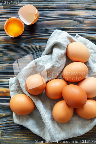 Image of Fresh chicken brown eggs on a linen towel.