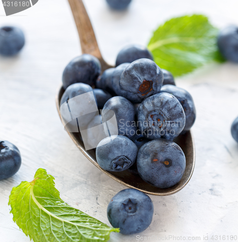 Image of Ripe blueberries in a tablespoon of closeup.