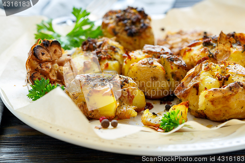 Image of Potatoes baked in their skins with spices closeup.