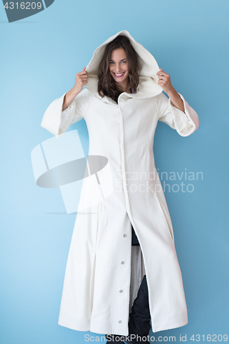 Image of woman in a white coat with hood isolated on blue background