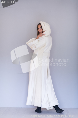 Image of woman in a white coat with hood isolated on white background