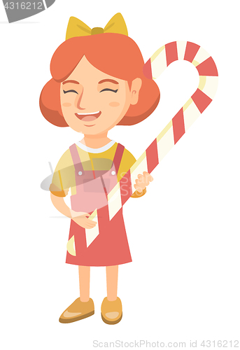 Image of Caucasian little girl holding christmas candy cane