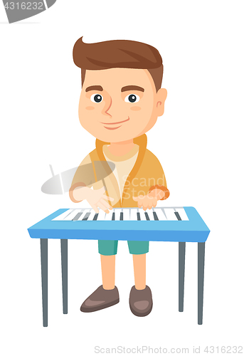 Image of Little caucasian boy playing the piano.