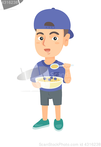Image of Happy boy holding a spoon and bowl of porridge.