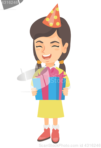 Image of Caucasian girl in birthday cap holding gift box.