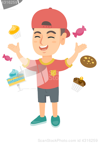 Image of Happy caucasian boy standing among lots of sweets.