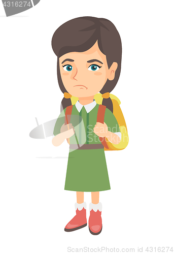 Image of Little caucasian sad schoolgirl carrying backpack.