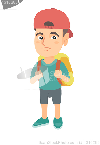 Image of Little caucasian sad schoolboy carrying a backpack